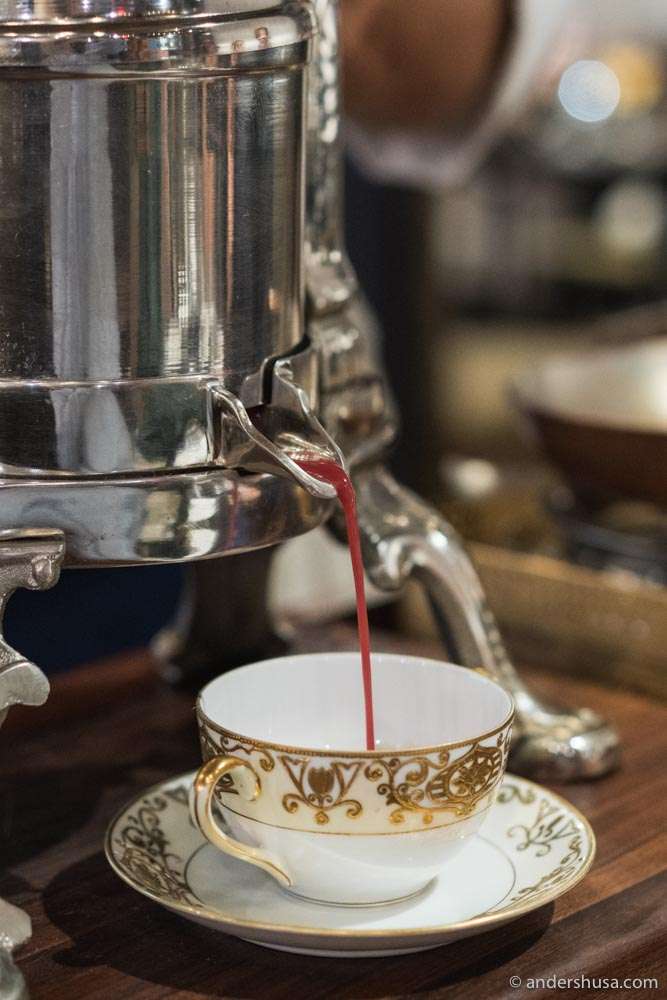 Duck sauce pouring from the antique press at Pasjoli